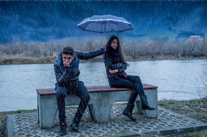 Couple sharing an umbrella in the rain