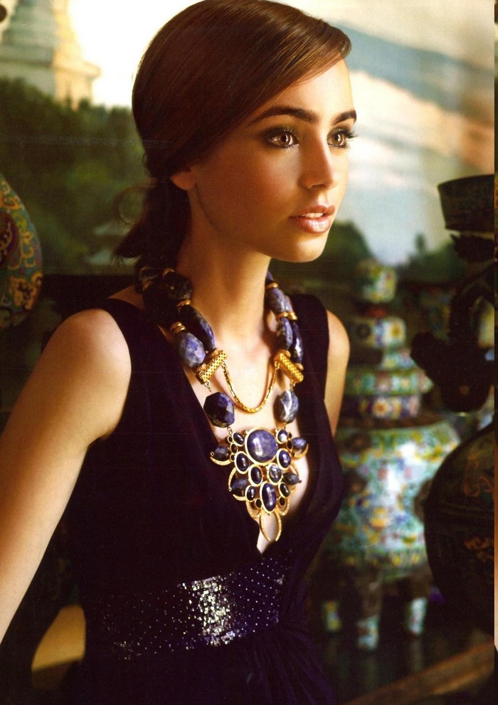 Lily Collins wearing a black dress and statement necklace