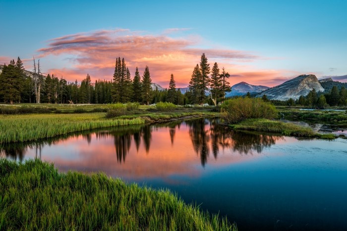 Sunset Reflection Over Serene Mountain River