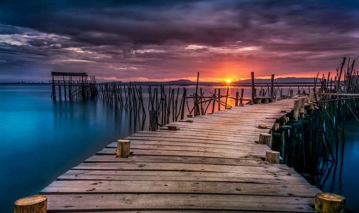 Wooden dock at sunset over the sea