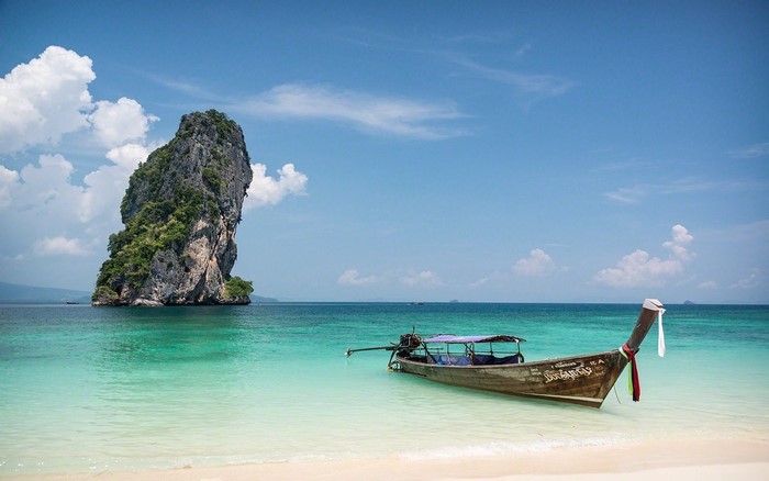 Longtail boat near a rocky island in Thailand