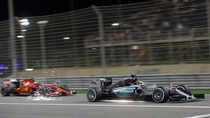 Formula 1 cars racing at night
