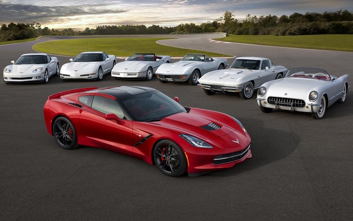 Chevrolet Corvettes from different generations on a racetrack