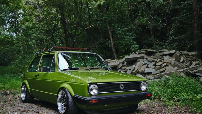 Green Volkswagen Golf I in forest