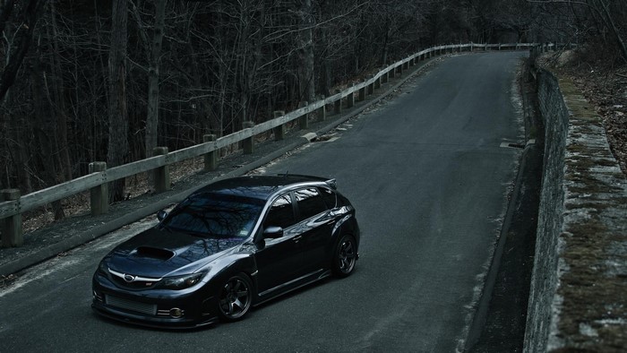 Dark Subaru Impreza WRX STI on a Winding Road