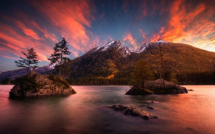 Sunset over a mountain lake with islands and trees