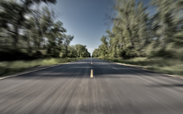 Road with trees and motion blur
