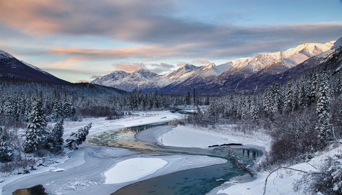 Snowy mountain landscape with a winding river in Alaska