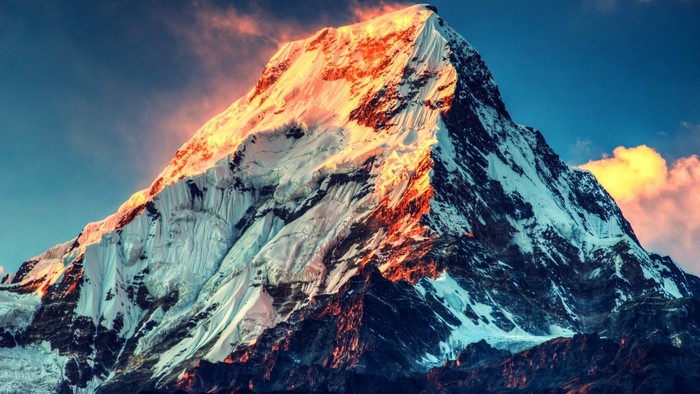 Snow-capped mountain peak at sunrise