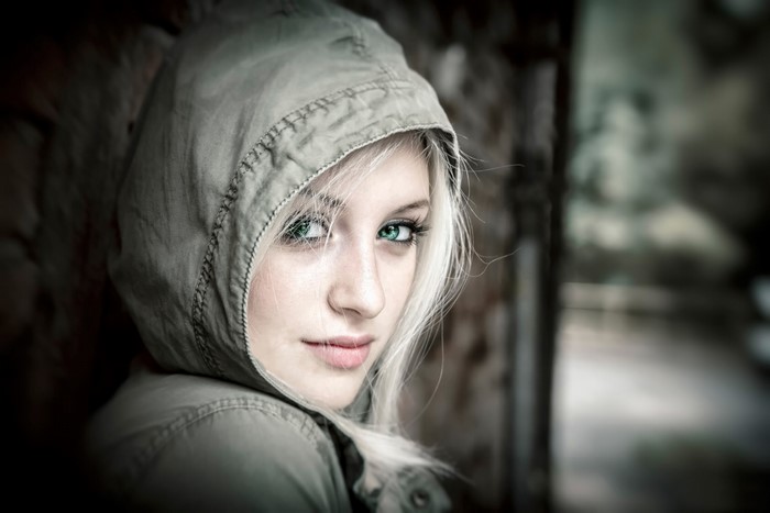 Woman with green eyes and blonde hair wearing a hood