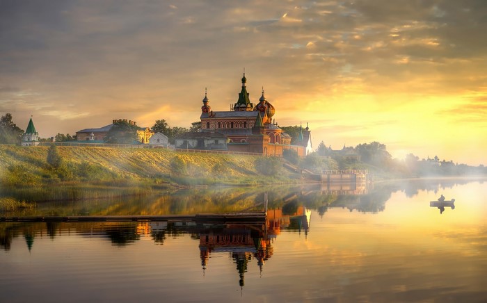 Monastery on the riverbank at sunrise, Russia