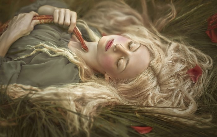 Woman with snake in grass