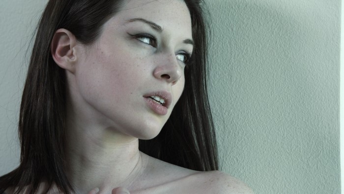 Woman with dark hair and freckles
