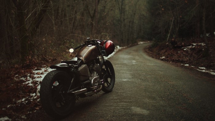 Bobber motorcycle on a snowy forest road