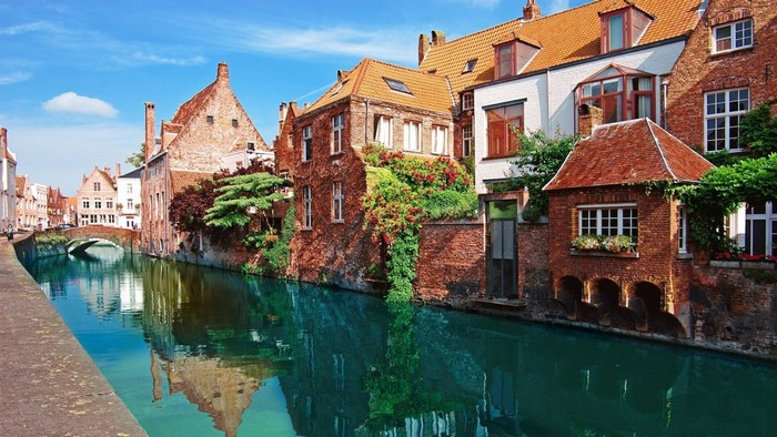 Bruges city river canal with historic buildings and bridge