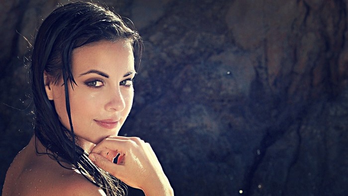 Woman with dark hair and green eyes