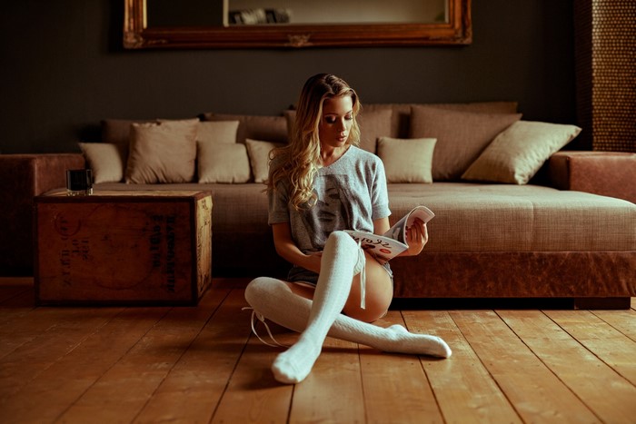 Woman reading a magazine on the floor