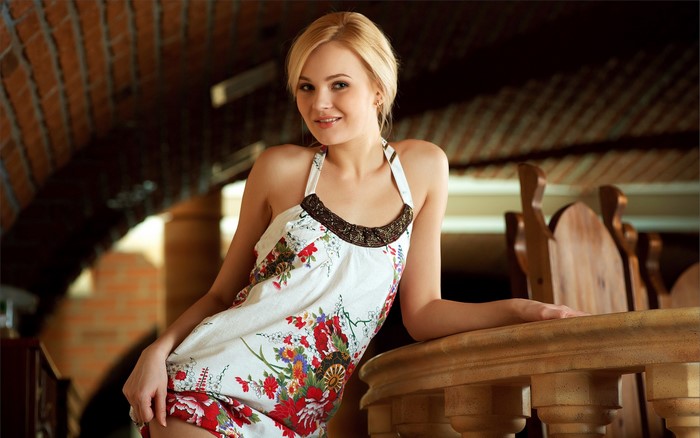 Woman with blonde hair wearing a floral dress