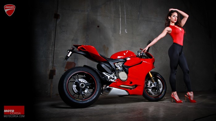 Woman in red bodysuit and black leggings with Ducati motorcycle