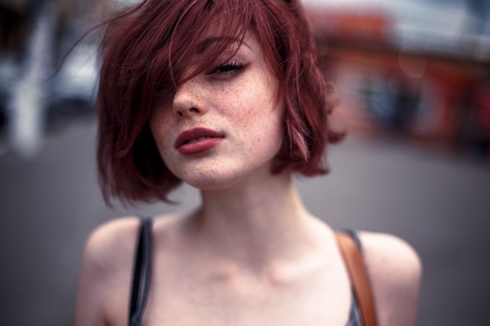 Redhead woman with freckles looking at viewer