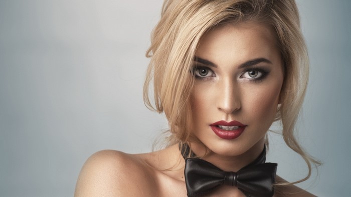 Woman with blonde hair and bow tie