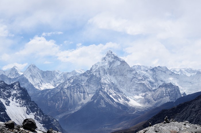 Snow-capped mountains under a cloudy sky