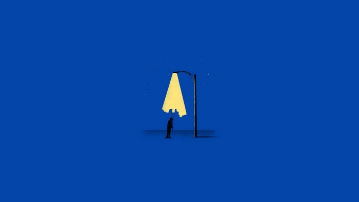 Man holding a street lamp with a city silhouette