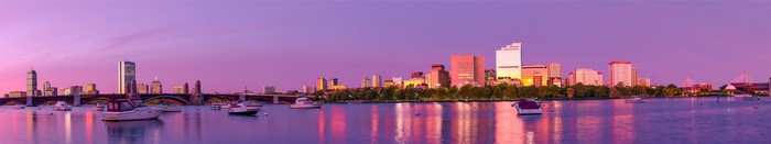 Boston skyline at sunset with Charles River and boats
