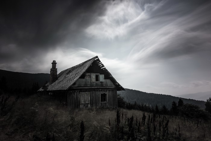 Mysterious Old House Ruin in Moody Landscape