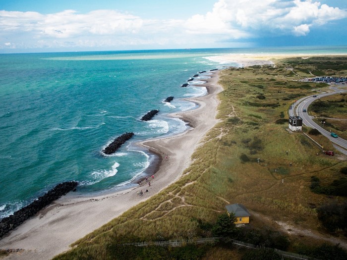 Aerial view of a Danish coastline with a road and a house