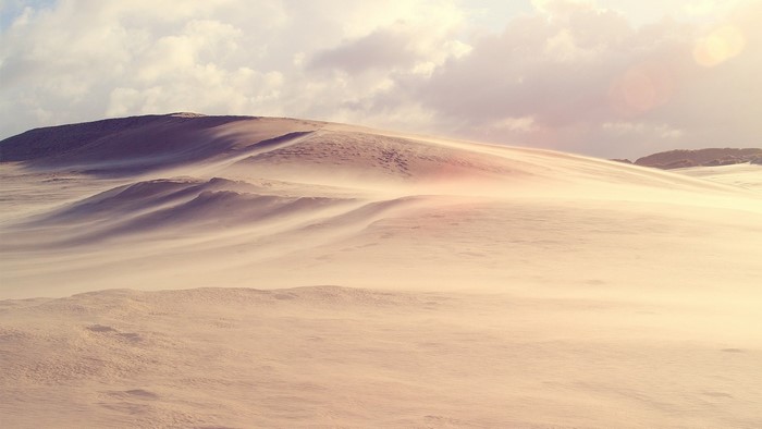 Sand dunes with wind blowing sand