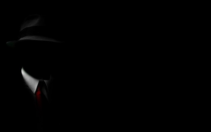 Man in fedora and suit with red tie