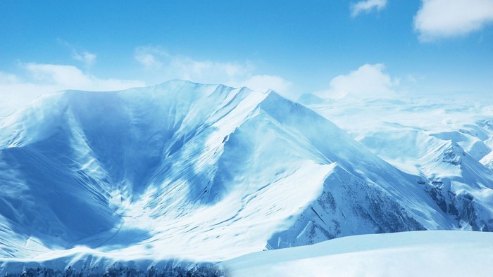 Snowy mountain range under a blue sky