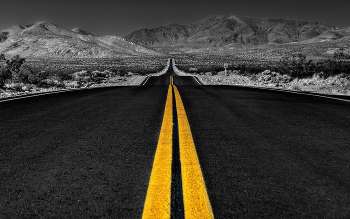 Empty desert highway with yellow lines
