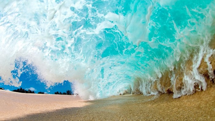Wave crashing on a sandy beach