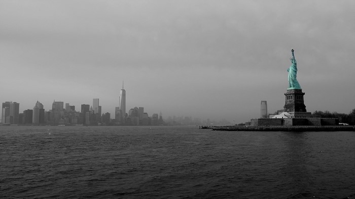Statue of Liberty and Manhattan Skyline over Water