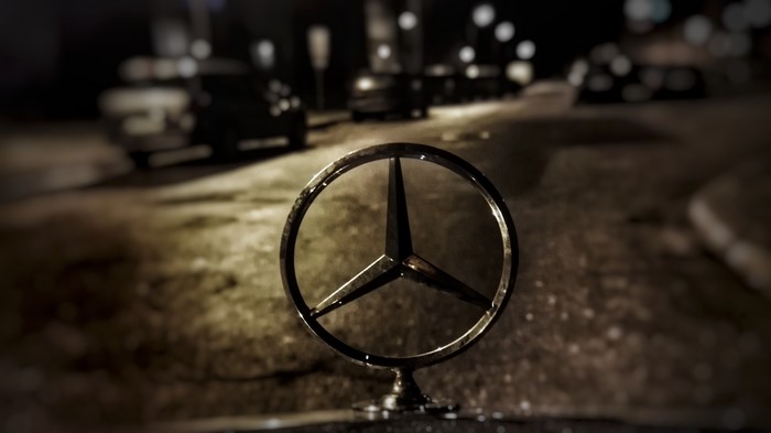 Mercedes-Benz Logo Close-Up on Night Street