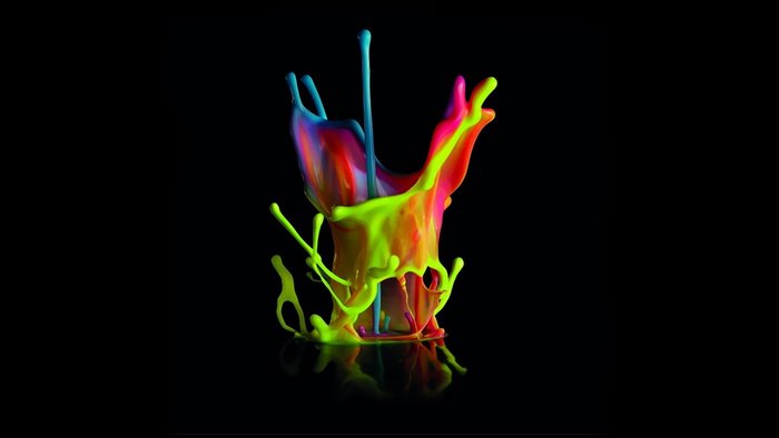 Colorful paint splashes on black background