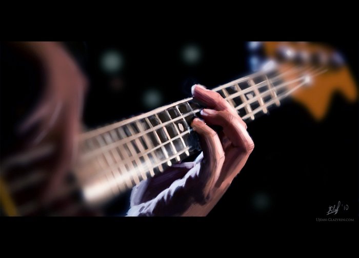 Close-up of a hand playing a bass guitar