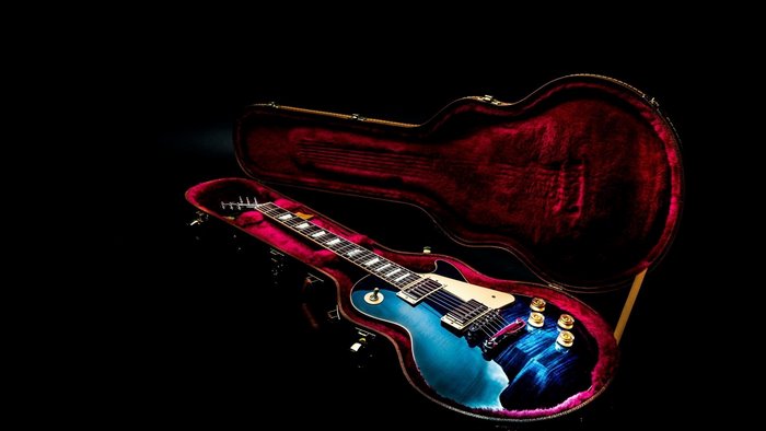 Blue electric guitar in a red case