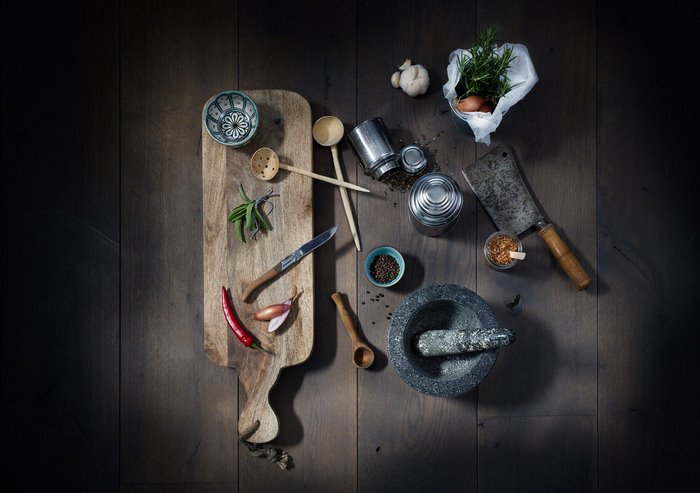 Kitchen utensils and ingredients on a wooden surface