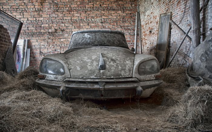 Abandoned Citroen DS car in a barn