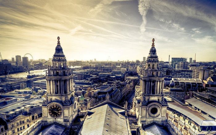 London cityscape with St. Paul's Cathedral towers and the London Eye