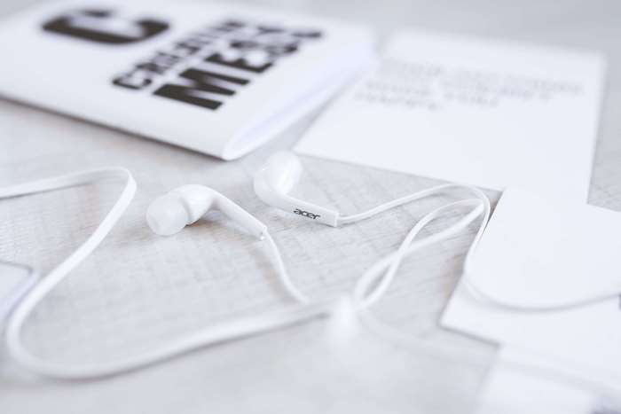 White Acer Earphones and Papers on a Desk