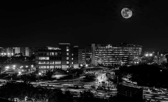 Cityscape at night with full moon