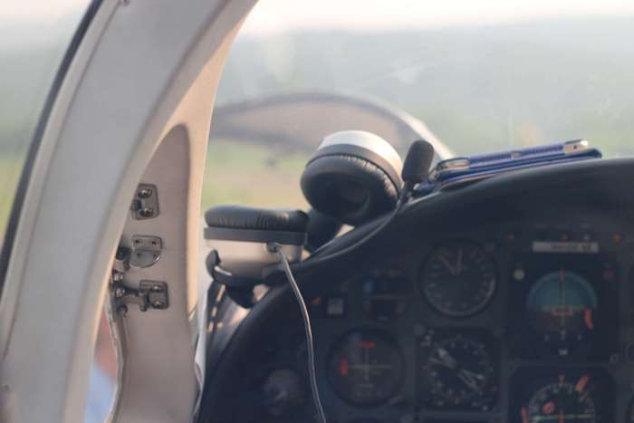 Cockpit of an airplane with headphones and phone