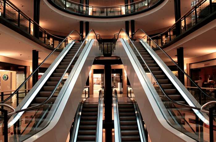 Shopping mall interior with escalators