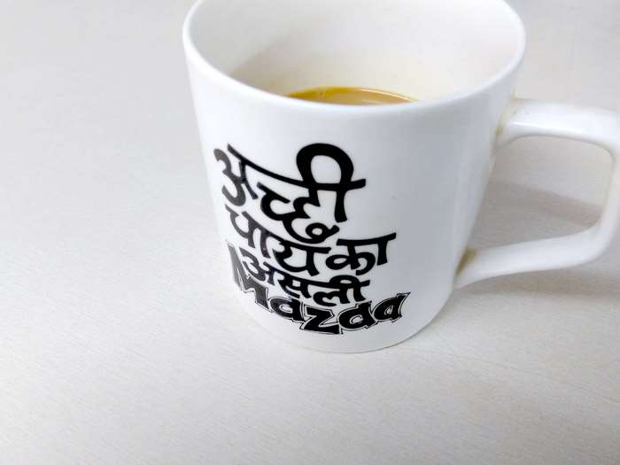 White mug with Hindi text about tea