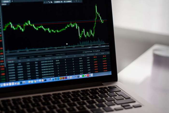 Laptop displaying stock market trading charts and data