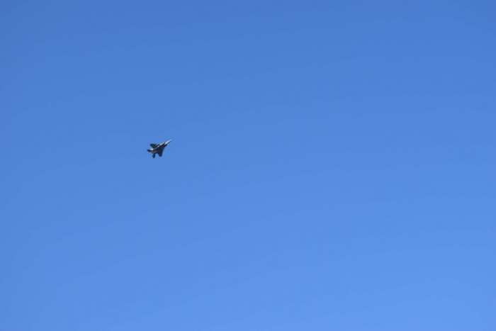 Military jet flying in a clear blue sky 4K